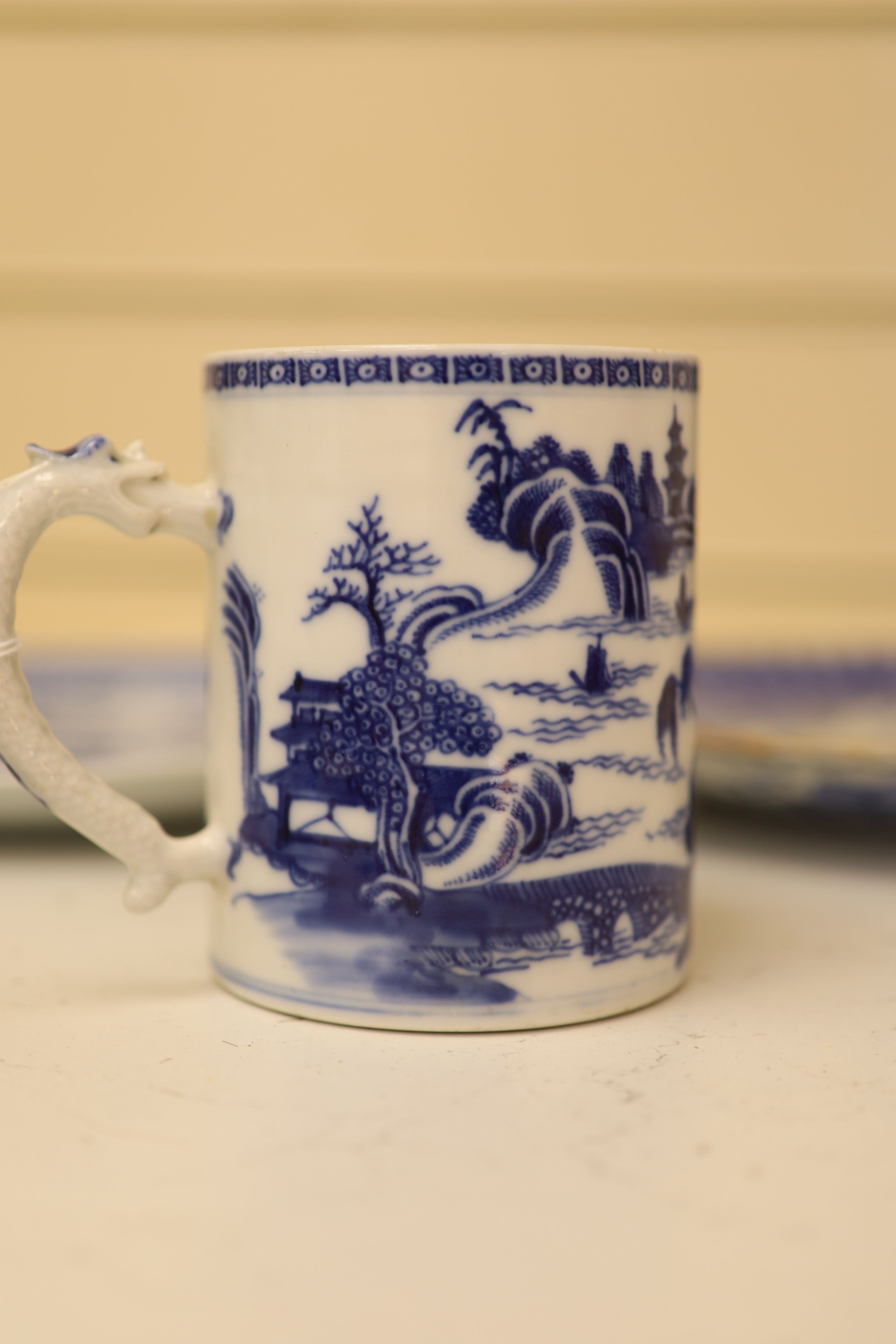 An 18th century Chinese blue and white mug and cup, a 19th century Chinese blue and white plate and a Japanese plate